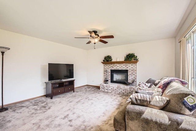living room featuring carpet floors, ceiling fan, baseboards, and a fireplace