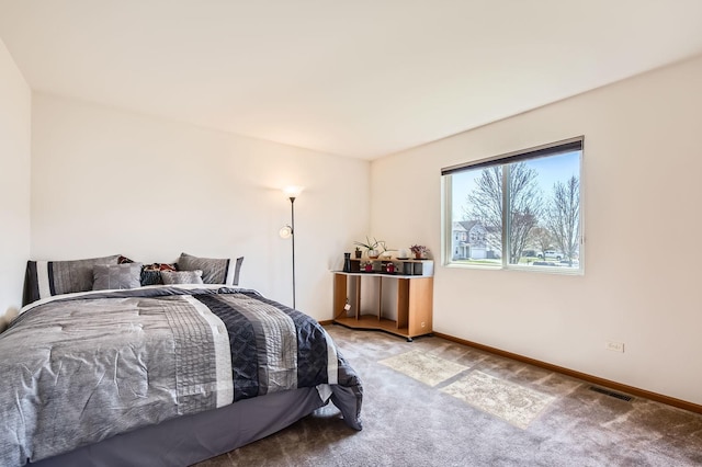 carpeted bedroom with baseboards and visible vents