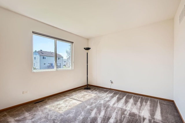 unfurnished room with carpet floors, baseboards, and visible vents