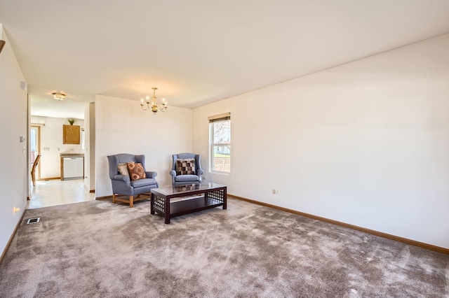 living area with visible vents, baseboards, carpet, and an inviting chandelier