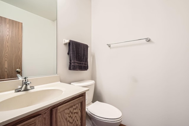 bathroom featuring toilet and vanity
