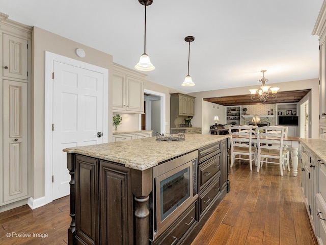 2 Stirrup Cup Ct, Saint Charles, IL 60174 - kitchen featuring stainless steel microwave, dark wood-style flooring, a chandelier, light stone counters, and hanging light fixtures