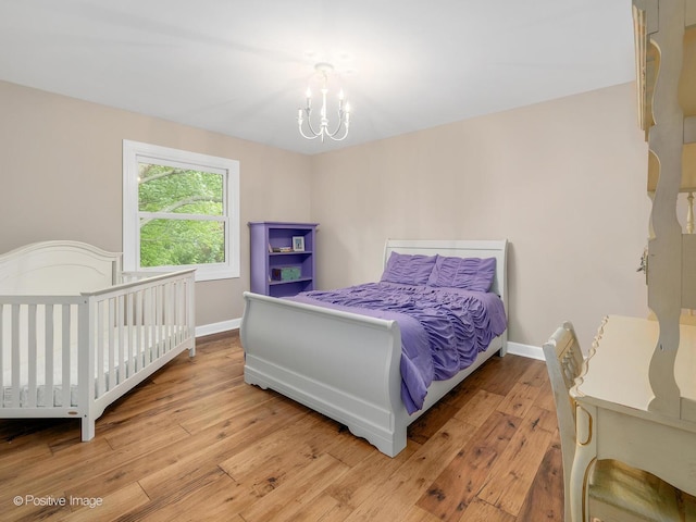 2 Stirrup Cup Ct, Saint Charles, IL 60174 - bedroom featuring light wood-style floors, a chandelier, and baseboards