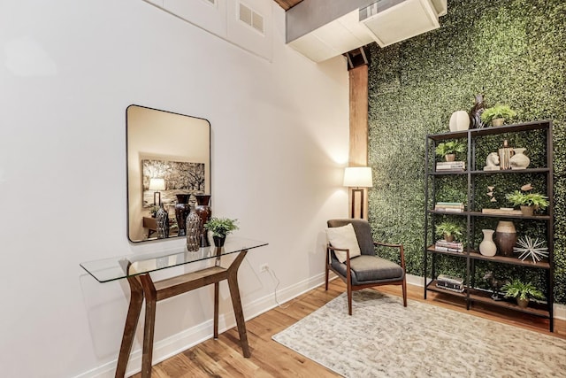 sitting room featuring wood finished floors, baseboards, and visible vents