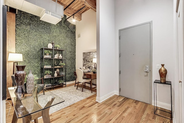 foyer entrance featuring wood finished floors and baseboards
