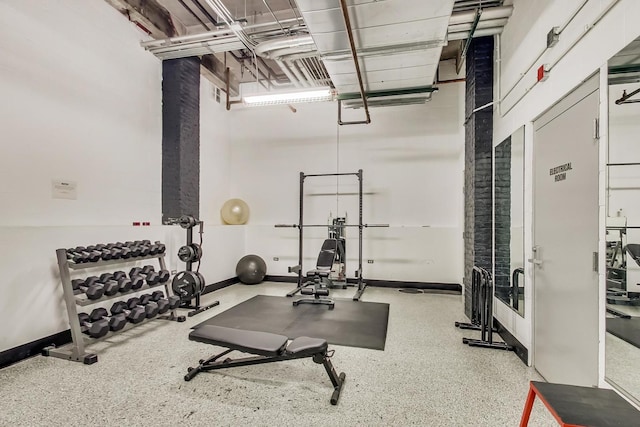 workout room featuring baseboards