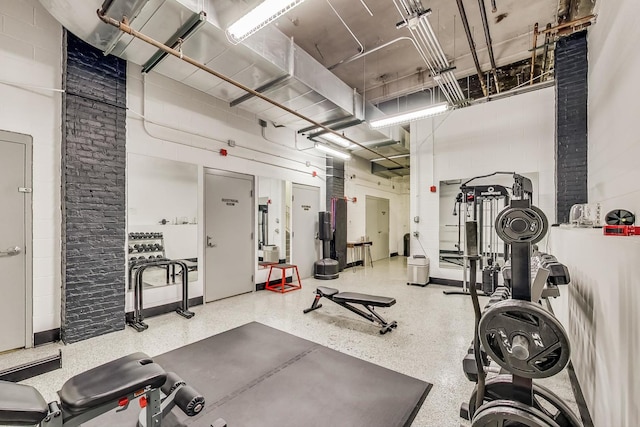 gym featuring concrete block wall