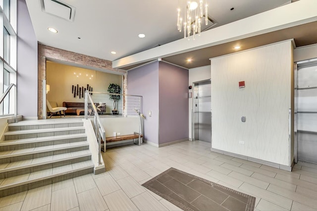 reception featuring visible vents, an inviting chandelier, and stairs