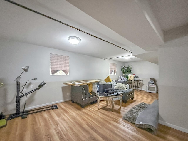 living area featuring baseboards and wood finished floors