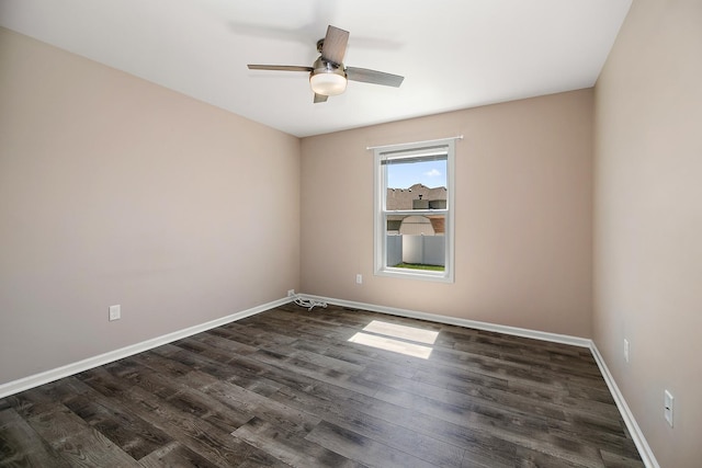 unfurnished room with dark wood-type flooring, baseboards, and ceiling fan