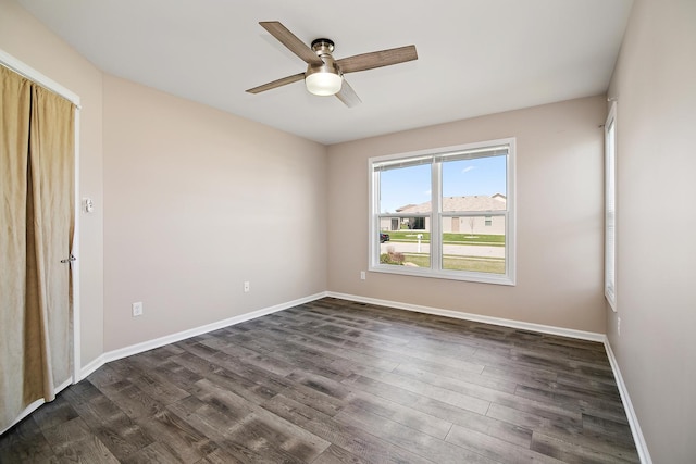unfurnished room with ceiling fan, baseboards, and dark wood-style floors