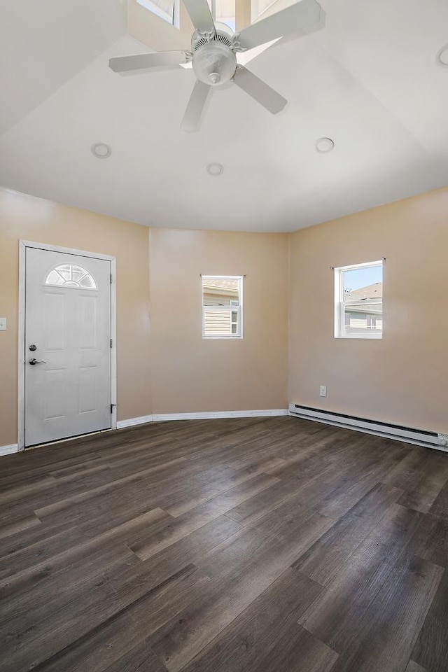 foyer entrance featuring a healthy amount of sunlight, a baseboard heating unit, ceiling fan, and dark wood-style flooring
