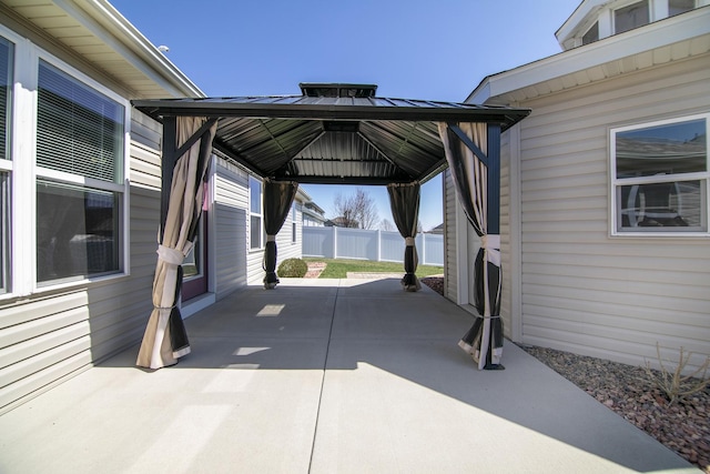 view of vehicle parking with a gazebo and fence