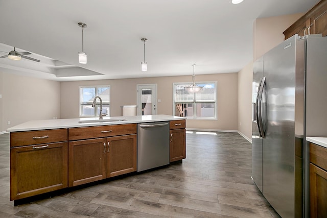 kitchen featuring dark wood-type flooring, appliances with stainless steel finishes, a sink, and plenty of natural light