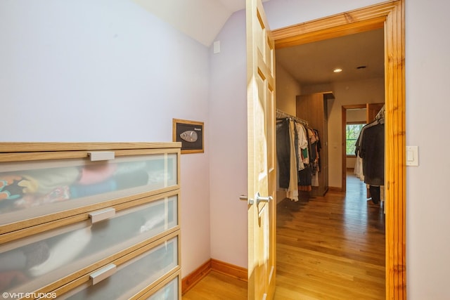 905 Basswood St, Hoffman Estates, IL 60169 - hallway featuring light wood finished floors, lofted ceiling, and baseboards