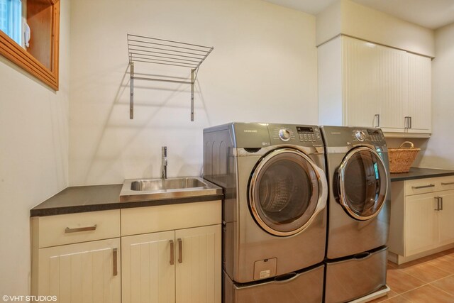 905 Basswood St, Hoffman Estates, IL 60169 - clothes washing area with cabinet space, washer and clothes dryer, and light tile patterned floors