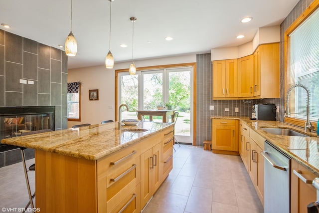 905 Basswood St, Hoffman Estates, IL 60169 - kitchen featuring stainless steel dishwasher, a sink, light stone counters, plenty of natural light, and recessed lighting
