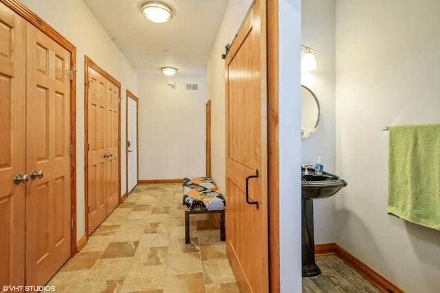 905 Basswood St, Hoffman Estates, IL 60169 - corridor featuring light stone finish flooring and baseboards