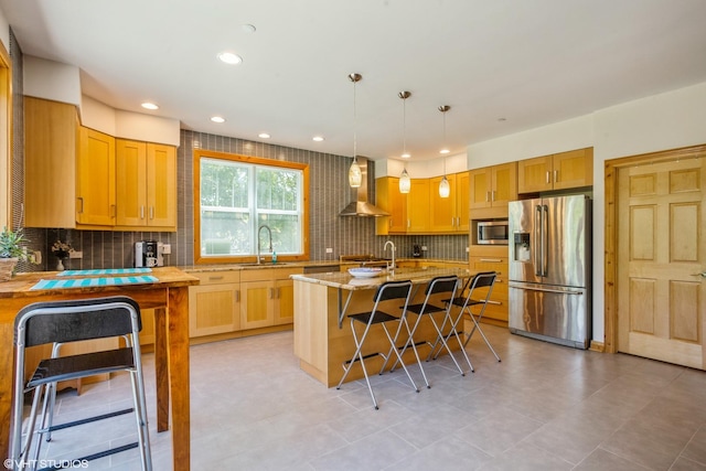 905 Basswood St, Hoffman Estates, IL 60169 - kitchen featuring appliances with stainless steel finishes, wall chimney range hood, a sink, a breakfast bar area, and tasteful backsplash