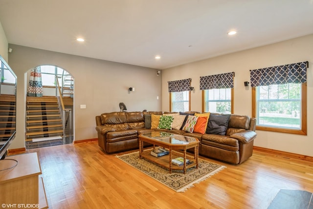 905 Basswood St, Hoffman Estates, IL 60169 - living room featuring stairway, light wood finished floors, arched walkways, recessed lighting, and baseboards