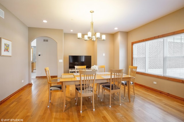 905 Basswood St, Hoffman Estates, IL 60169 - dining area featuring arched walkways, light wood finished floors, baseboards, a chandelier, and recessed lighting