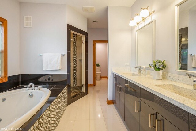 905 Basswood St, Hoffman Estates, IL 60169 - bathroom featuring toilet, a garden tub, tile patterned floors, double vanity, and a shower stall