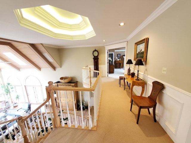 corridor with ornamental molding, recessed lighting, carpet flooring, wainscoting, and an upstairs landing