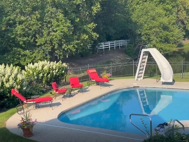 view of pool with a patio area, fence, and a fenced in pool