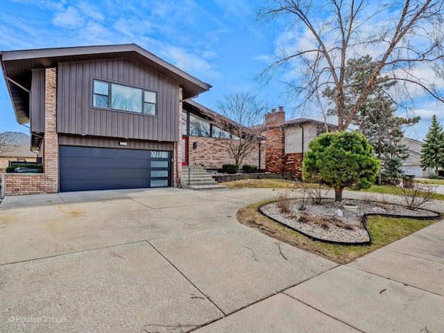 view of front of home featuring concrete driveway, brick siding, and an attached garage