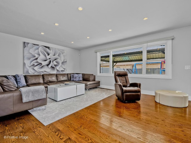 living room featuring recessed lighting, baseboards, and wood finished floors