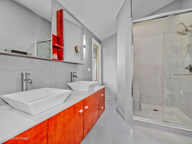 bathroom featuring a sink, tile patterned flooring, and a shower stall