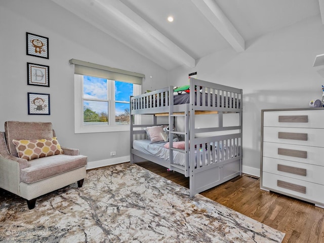 bedroom featuring baseboards, lofted ceiling with beams, and wood finished floors
