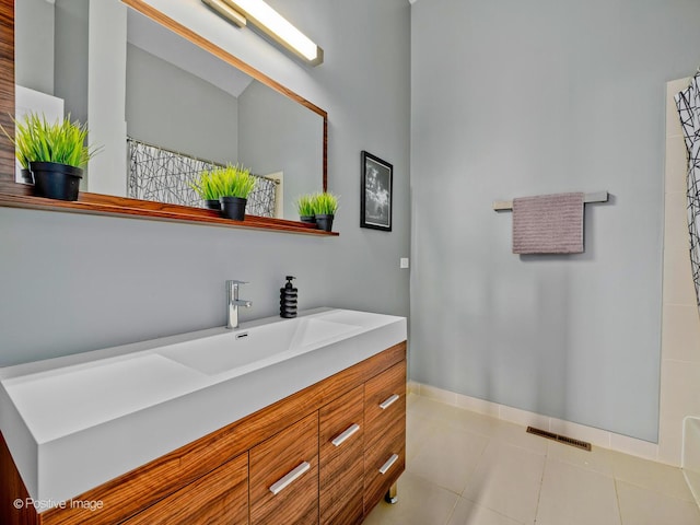 full bathroom with visible vents, tile patterned flooring, curtained shower, baseboards, and vanity