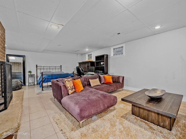 tiled living area with baseboards, recessed lighting, and a paneled ceiling