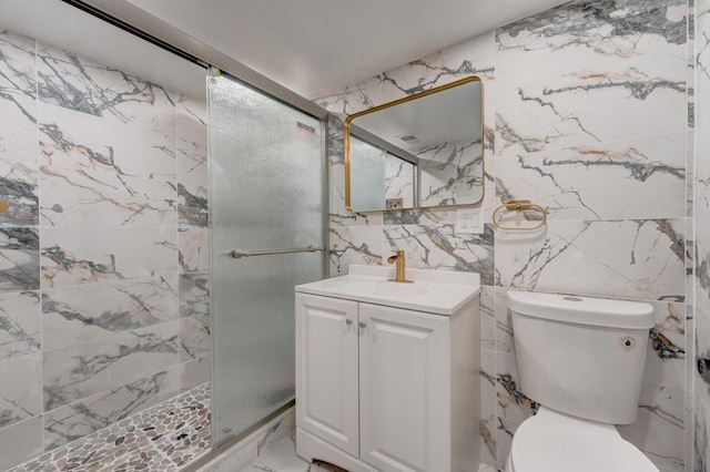 bathroom with marble finish floor, toilet, vanity, and a stall shower