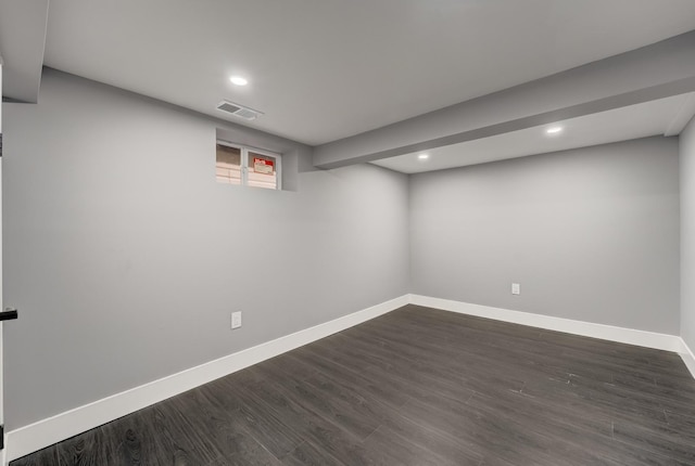 below grade area featuring baseboards, dark wood-style flooring, and recessed lighting