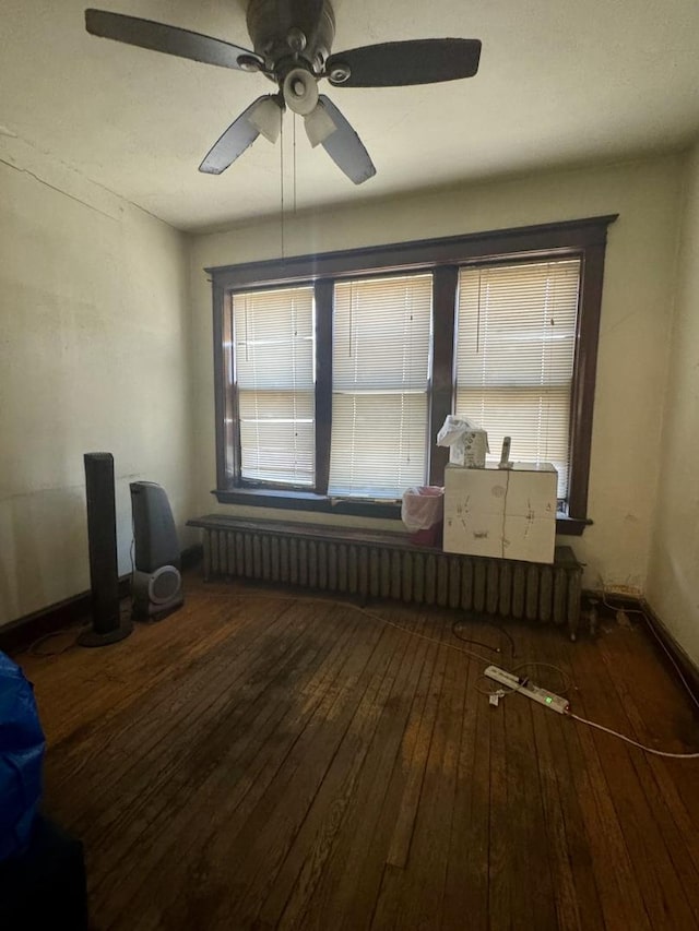 spare room with ceiling fan and wood-type flooring