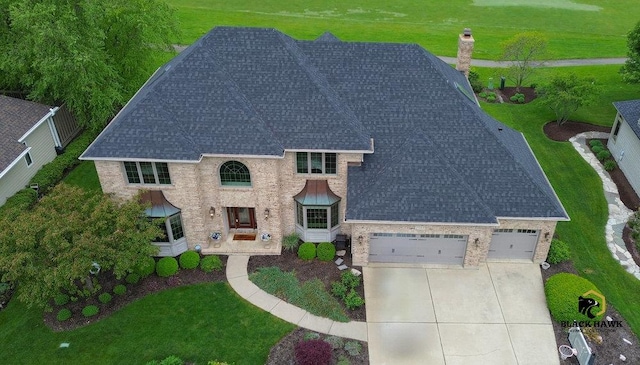 1583 Pine Lake Dr, Naperville, IL 60564 - view of front of house with a shingled roof, driveway, a chimney, an attached garage, and a front lawn