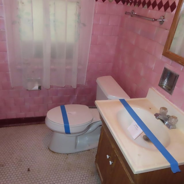4938 W Wrightwood Ave, Chicago, IL 60639 - bathroom featuring tile walls, toilet, tile patterned floors, and vanity