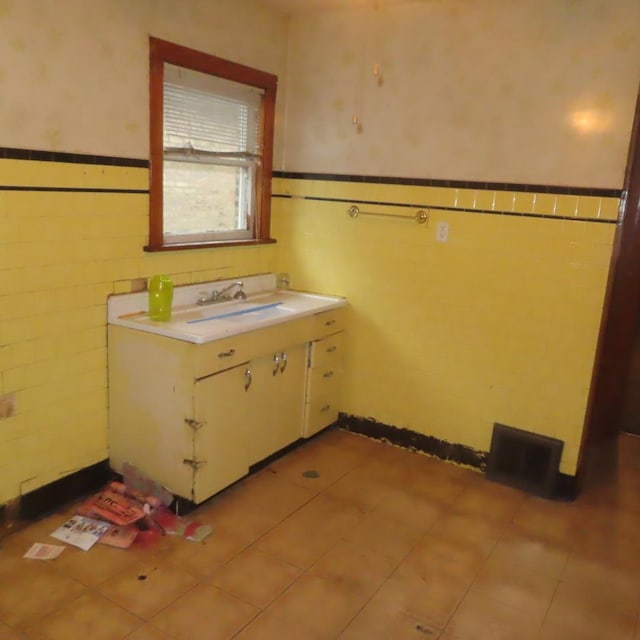 4938 W Wrightwood Ave, Chicago, IL 60639 - bathroom featuring tile patterned floors, vanity, tile walls, and wainscoting