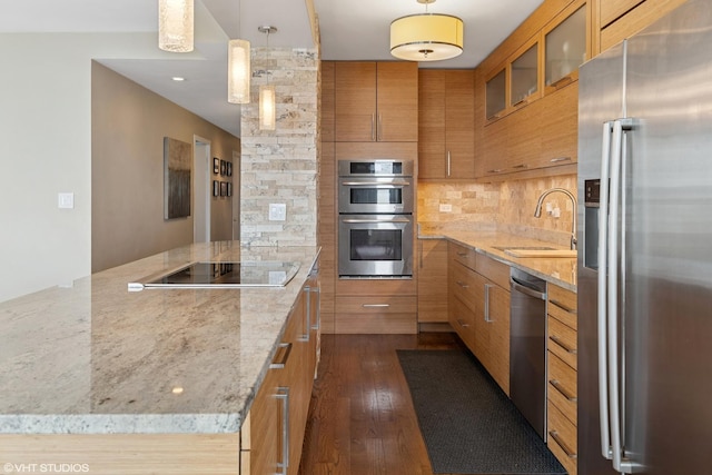 3180 N Lake Shore Dr Unit 15A, Chicago, IL 60657 - kitchen with appliances with stainless steel finishes, brown cabinets, dark wood finished floors, a sink, and glass insert cabinets