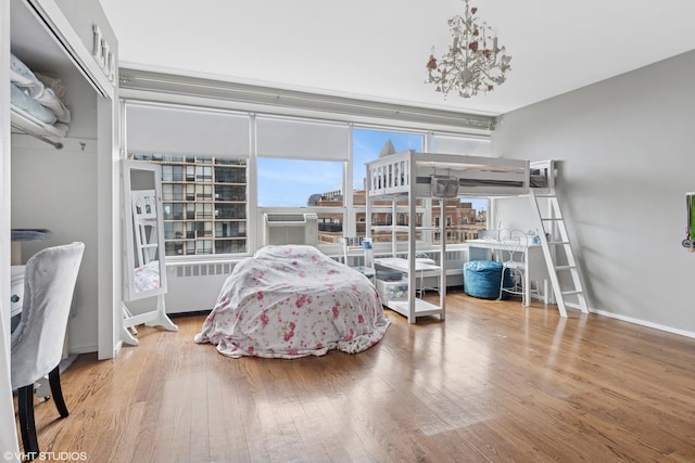 3180 N Lake Shore Dr Unit 15A, Chicago, IL 60657 - bedroom featuring baseboards, a chandelier, radiator heating unit, and wood finished floors