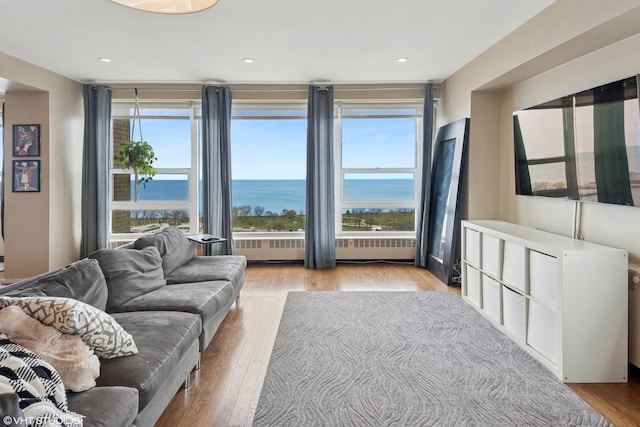 3180 N Lake Shore Dr Unit 15A, Chicago, IL 60657 - living area with wood finished floors, a water view, radiator heating unit, and a healthy amount of sunlight