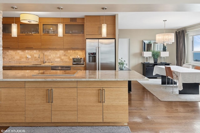 3180 N Lake Shore Dr Unit 15A, Chicago, IL 60657 - kitchen with tasteful backsplash, wood finished floors, a sink, dishwashing machine, and high end fridge