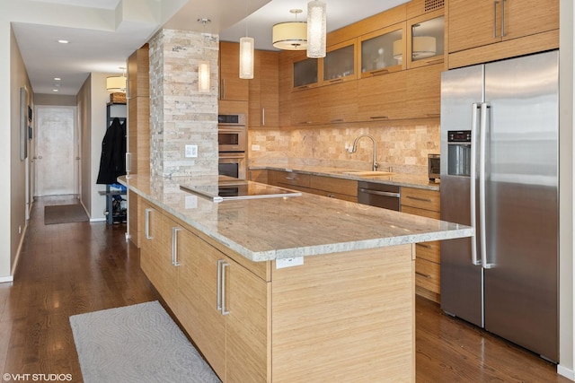 3180 N Lake Shore Dr Unit 15A, Chicago, IL 60657 - kitchen featuring brown cabinetry, glass insert cabinets, a sink, backsplash, and stainless steel appliances