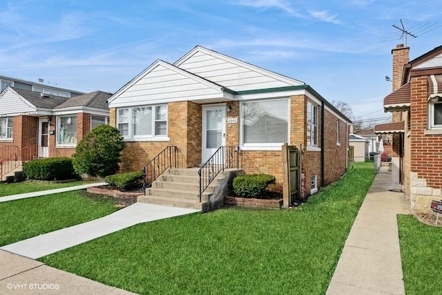 bungalow-style house featuring brick siding and a front yard