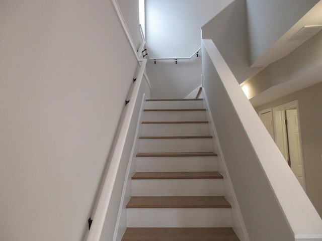 staircase featuring visible vents