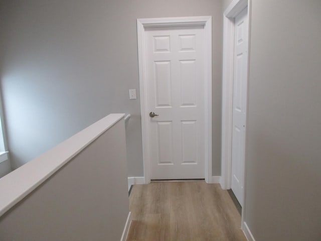 hallway with baseboards and light wood-type flooring