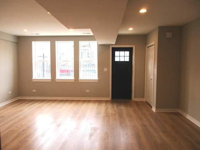 entrance foyer featuring baseboards, wood finished floors, and recessed lighting