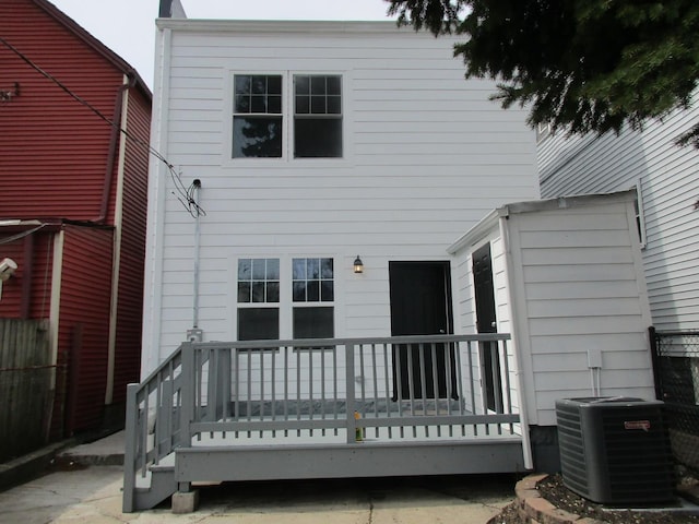 rear view of house featuring central AC